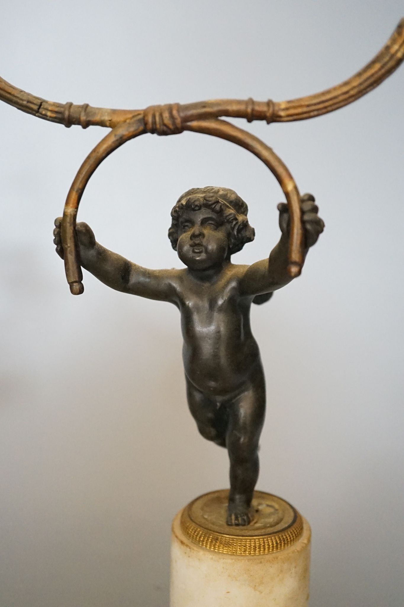 A pair of 19th century bronze and ormolu cherub candelabra, on alabaster plinths, 33cm